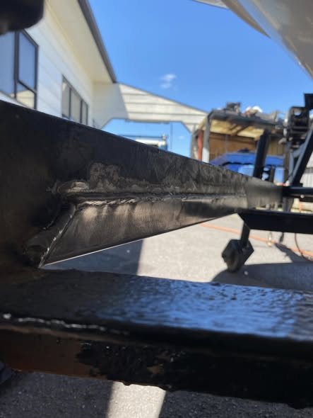 Welded angled plates on a boat trailer